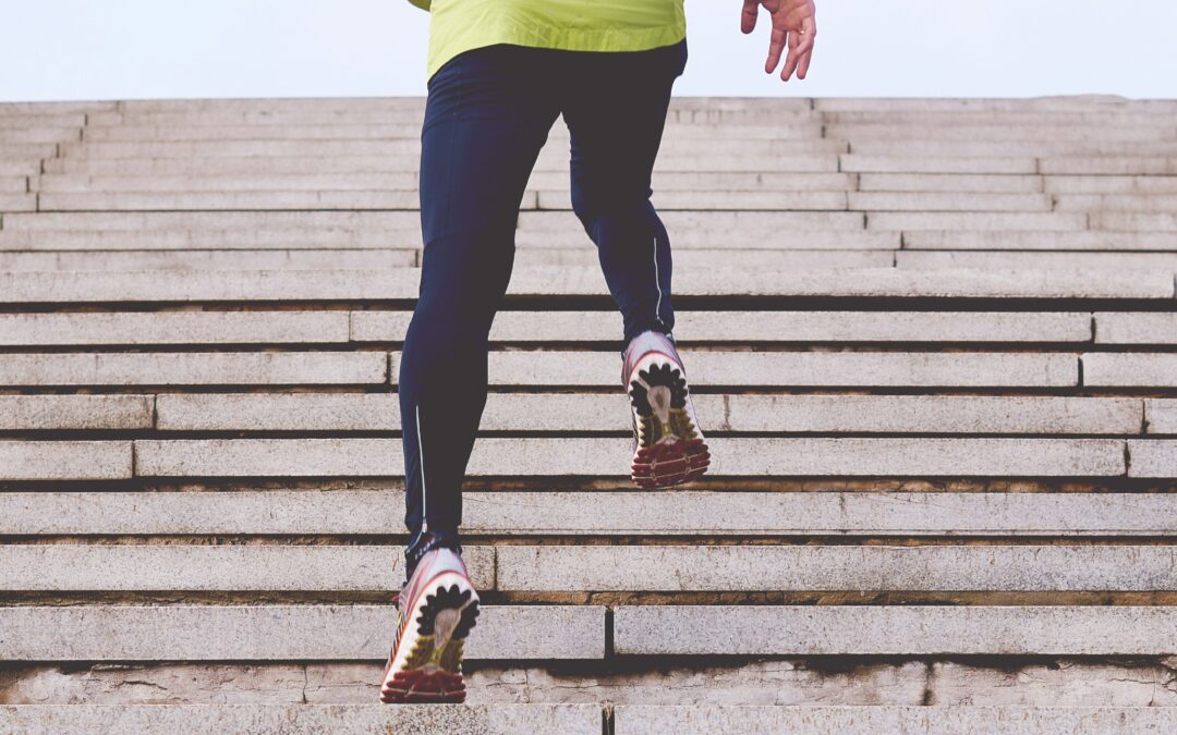 Person in athletic gear climbing concrete stairs, symbolizing the step-by-step process of business incorporation in Ontario.